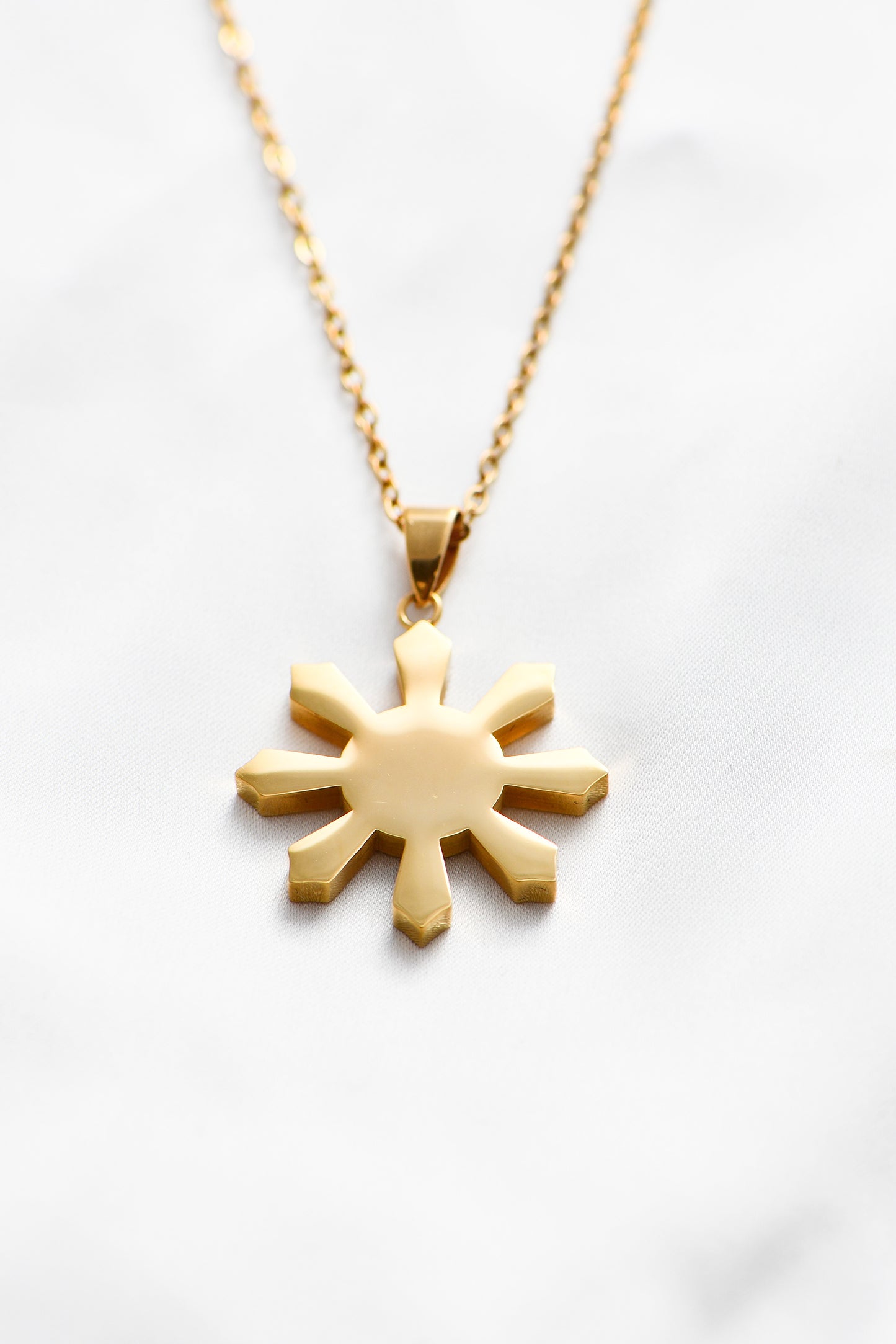 18K Gold Plated Mabuhay Sun on a white background. By DBL Jewelry