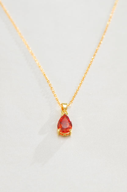 A gold-filled necklace with a teardrop-shaped red pendant, representing a Carnelian love amulet. by DBL Jewelry
