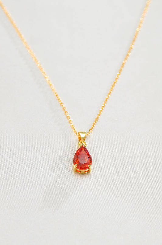 A gold-filled necklace with a teardrop-shaped red pendant, representing a Carnelian love amulet. by DBL Jewelry