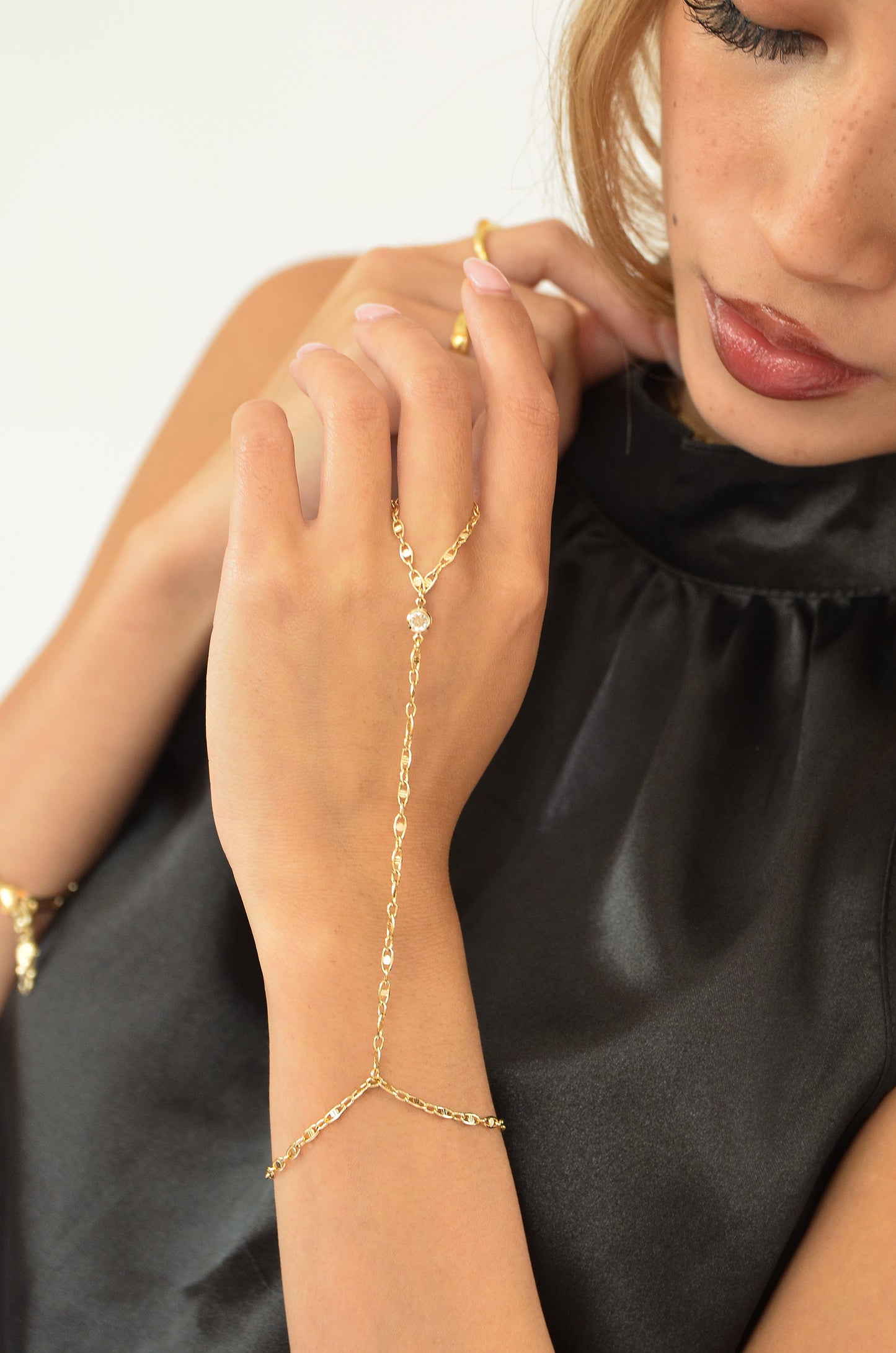 A model wearing the 18k Gold Filled Dyosa Hand Chain; By DBL Jewelry