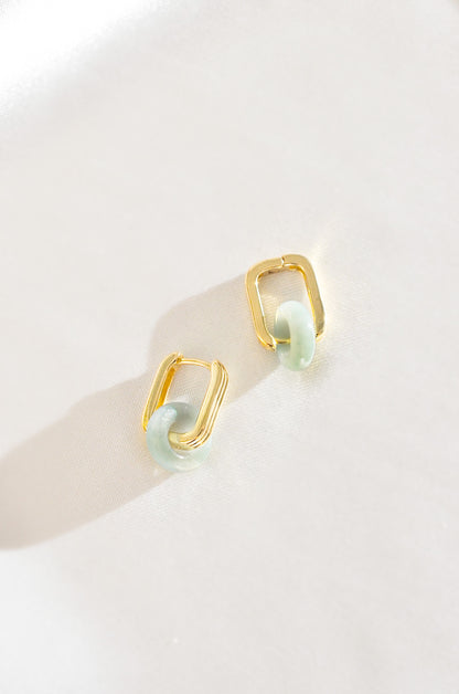 A pair of gold-filled earrings featuring green jade accents, displayed against a neutral background. By DBL Jewelry