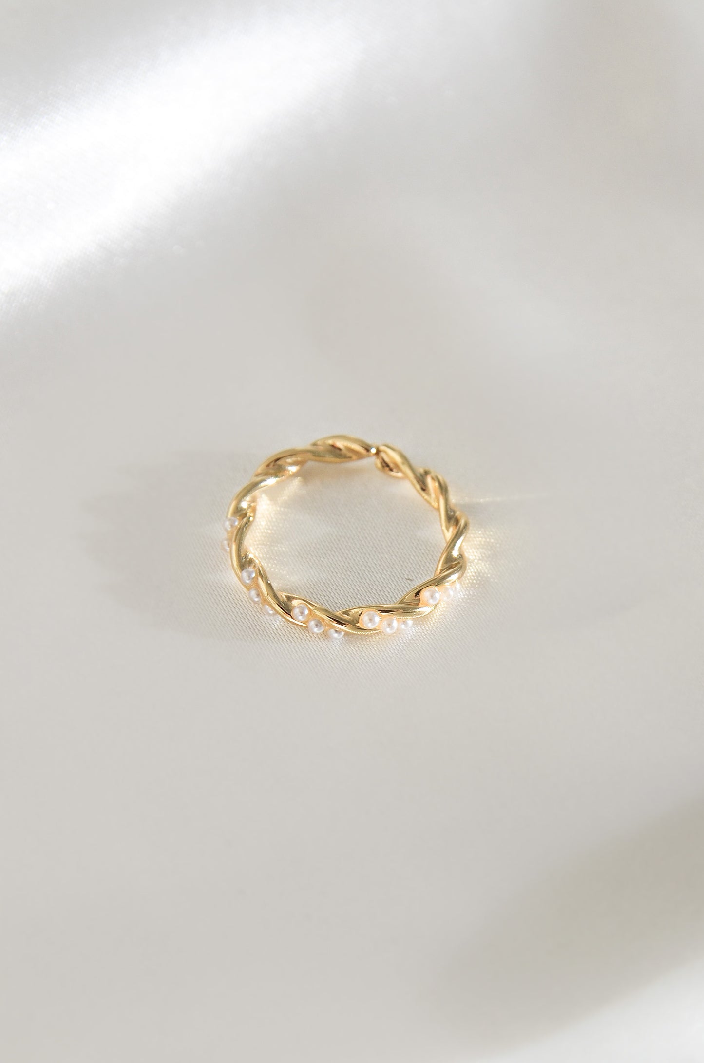 Palawan Pearl Ring, a gold twisted band with white pearls on a white background. By DBL Jewelry