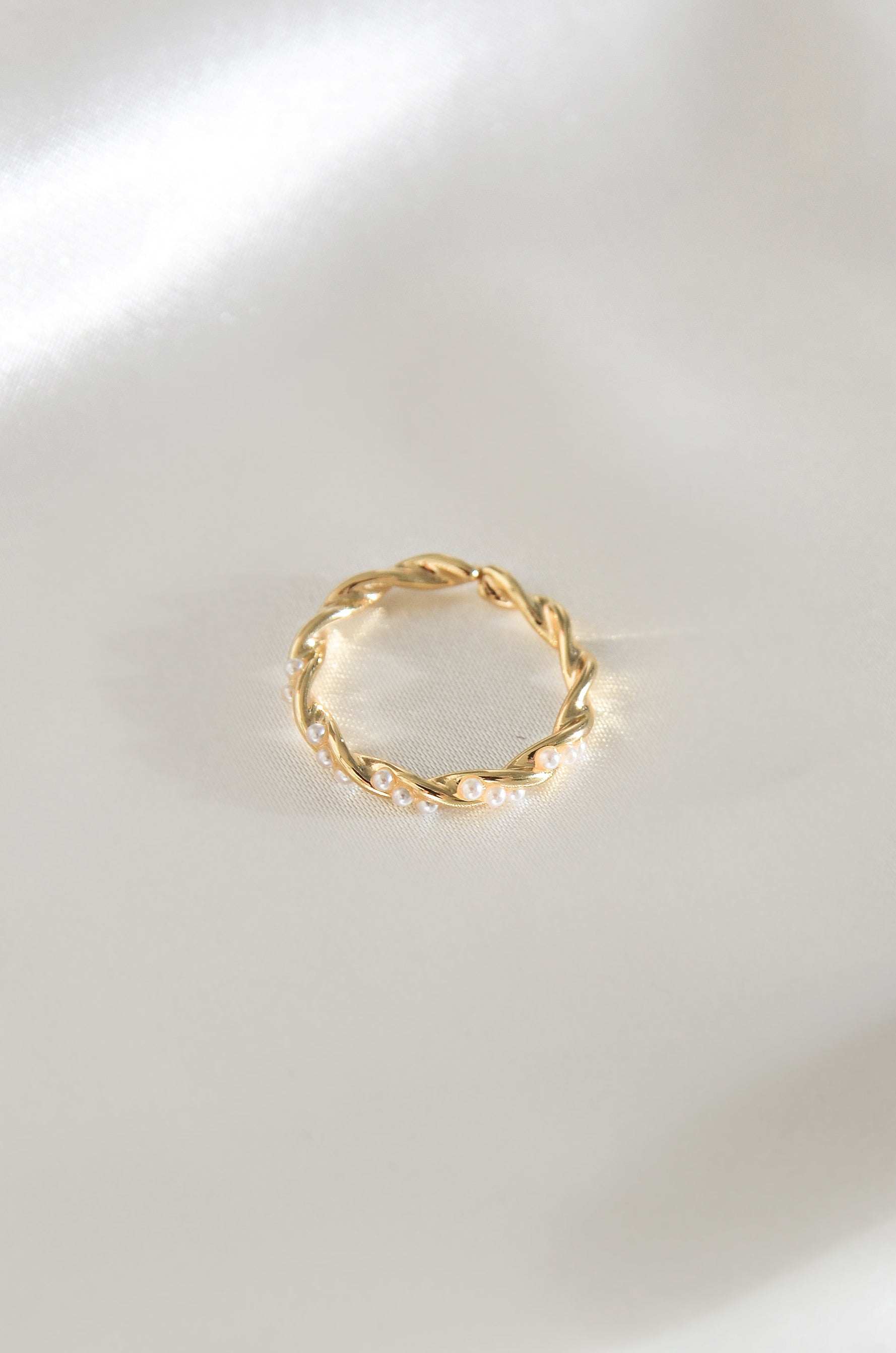 Palawan Pearl Ring, a gold twisted band with white pearls on a white background. By DBL Jewelry