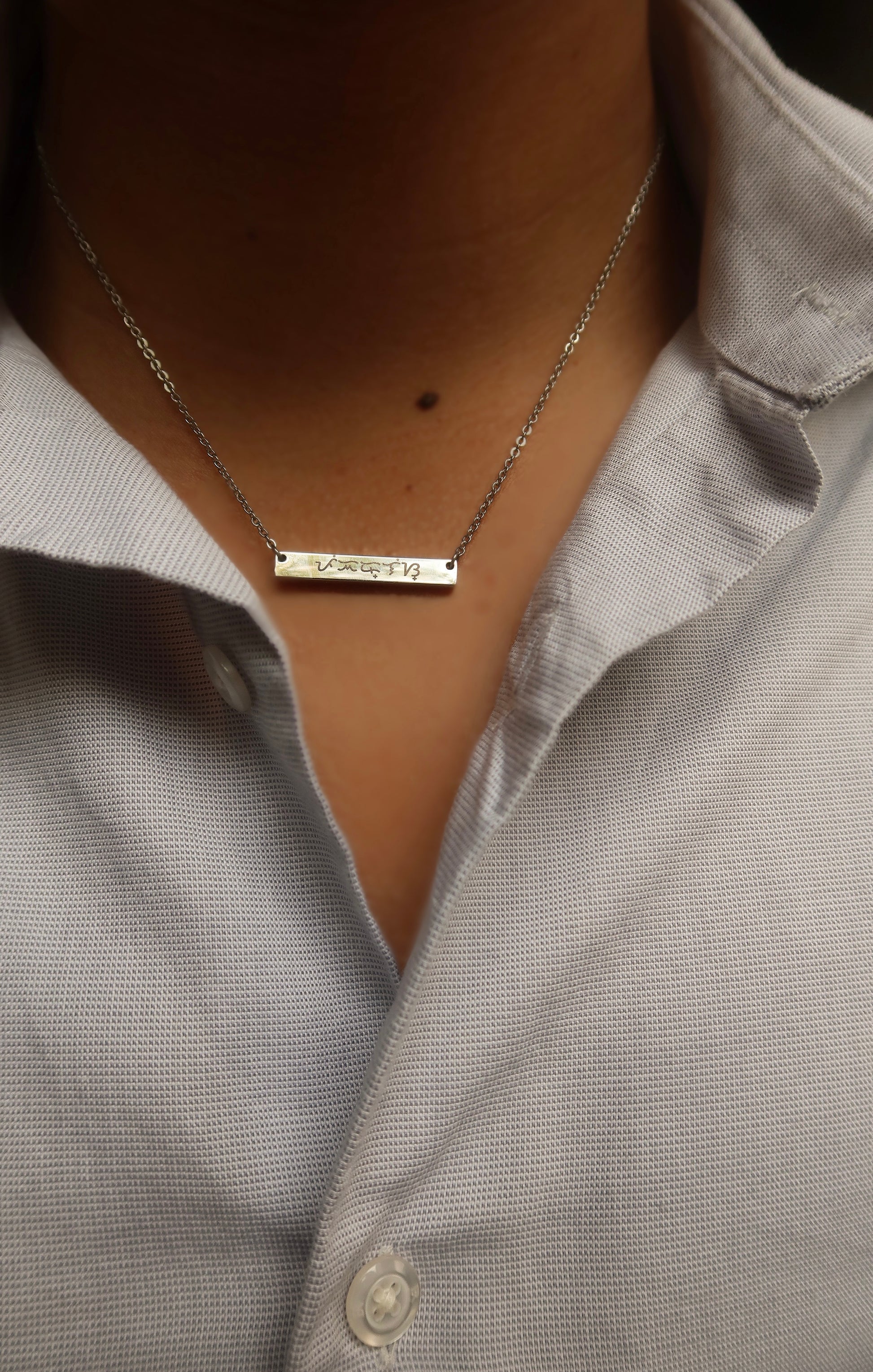 18K Electroplated Silver Stainless Steel Baybaying filipino script custom necklace on male model, piece of Filipino heritage as Baybayin is the ancient Filipino Writing System. Unisex Piece for Filipino Men and Women waterproof and Non-tarnish. by DBL Jewelry.