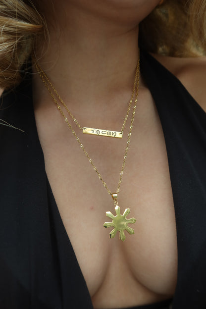 18K Electroplated Gold Stainless Steel Baybaying filipino script custom necklace on asian model, piece of Filipino heritage as Baybayin is the ancient Filipino Writing System. Unisex Piece for Filipino Men and Women waterproof and Non-tarnish. by DBL Jewelry.